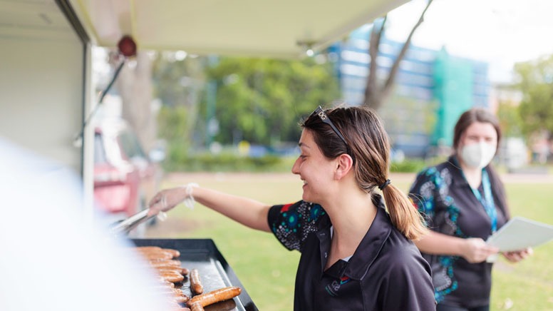 a women is grilling a hotdong