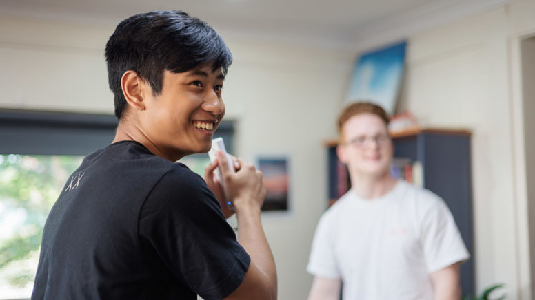 a smiling man while his presenting something